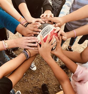 Kids hands on a volleyball